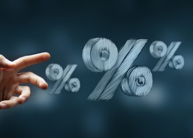 Hand reaching towards floating percentage symbols.