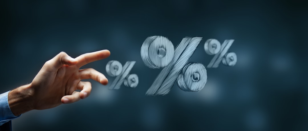 featured-fe56a8e2a2 Hand reaching towards floating percentage symbols.