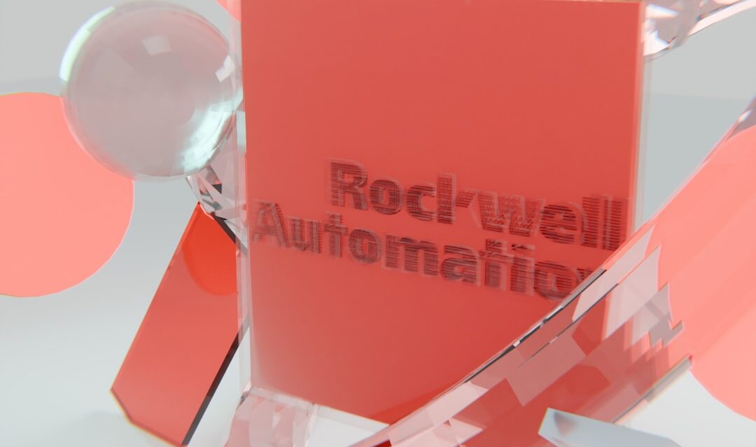 featured-5556a9fb2f Rockwell automation logo on a red block with abstract shapes.