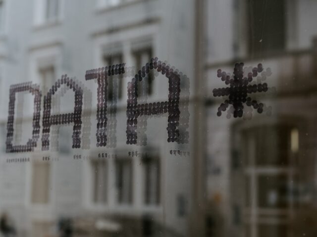 The word DATA and a star symbol stenciled in dark dots on glass