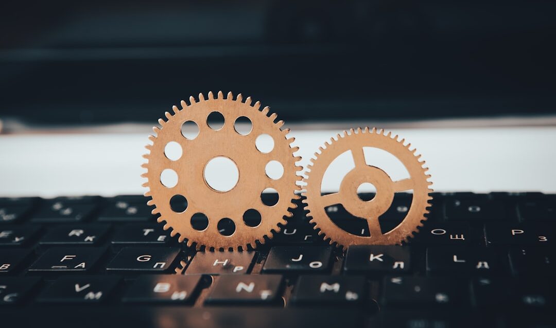 two wooden gears sitting on top of a keyboard