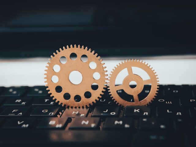 two wooden gears sitting on top of a keyboard