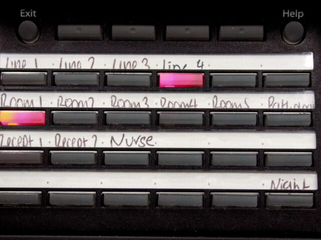 Buttons labeled with handwritten text on a control panel