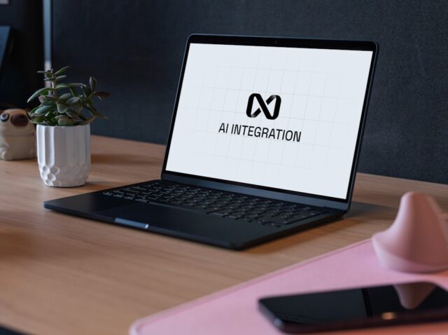 Laptop displaying ai integration logo on desk